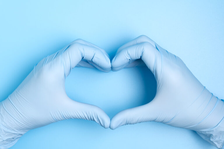 gloved hands in the shape of a heart